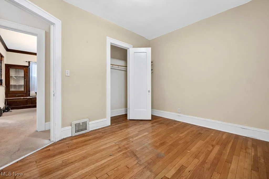 First Floor bedroom hard wood finished floors and a closet