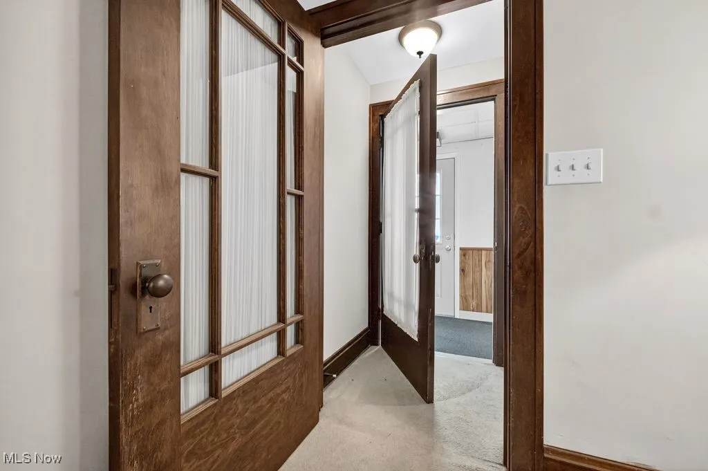 First Floor entrance with light carpet and baseboards