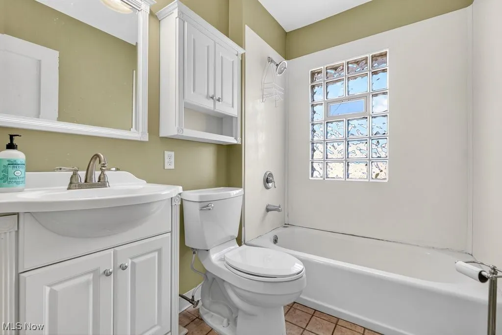 Second Floor Bathroom featuring tub / shower combination, vanity, and light tile patterned flooring