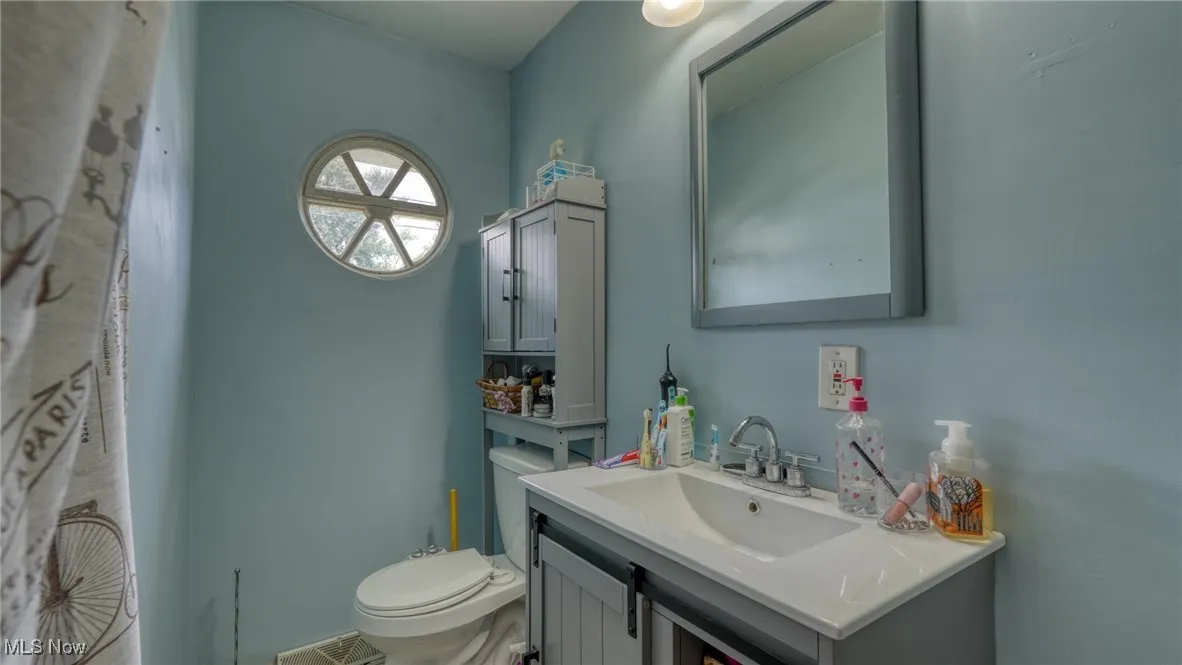 Half bath with vanity and toilet
