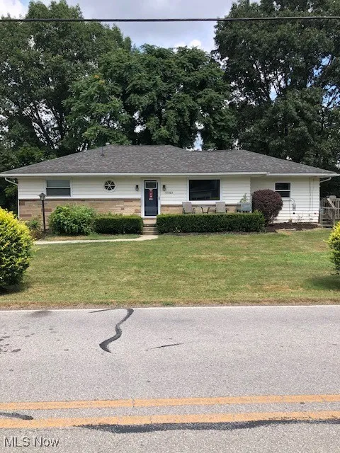 Ranch-style house featuring a front yard and brick siding