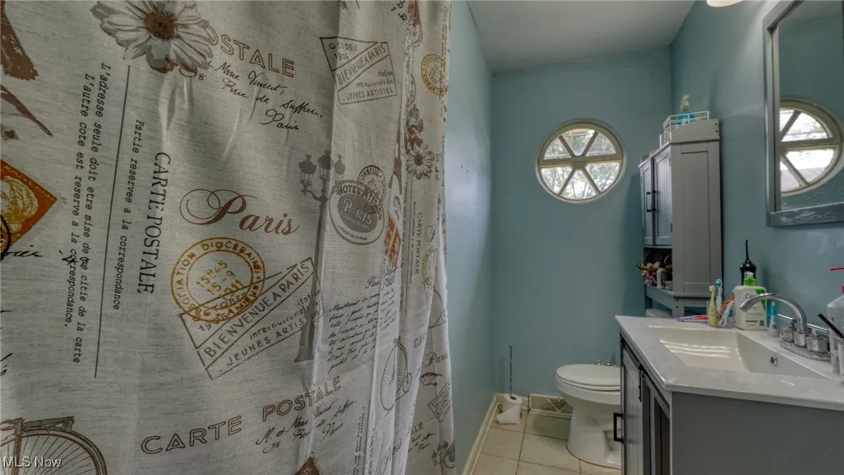 Bathroom with vanity and light tile patterned floors