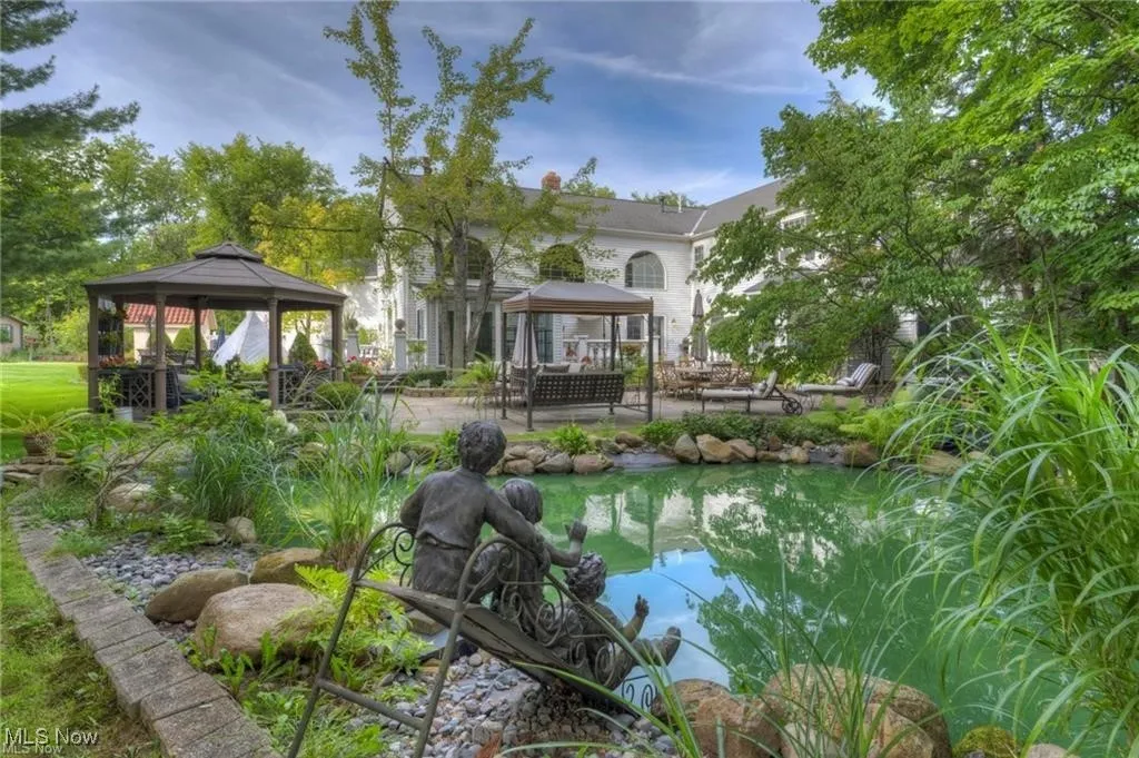 View of backyard pond, gazebo, and  patio,