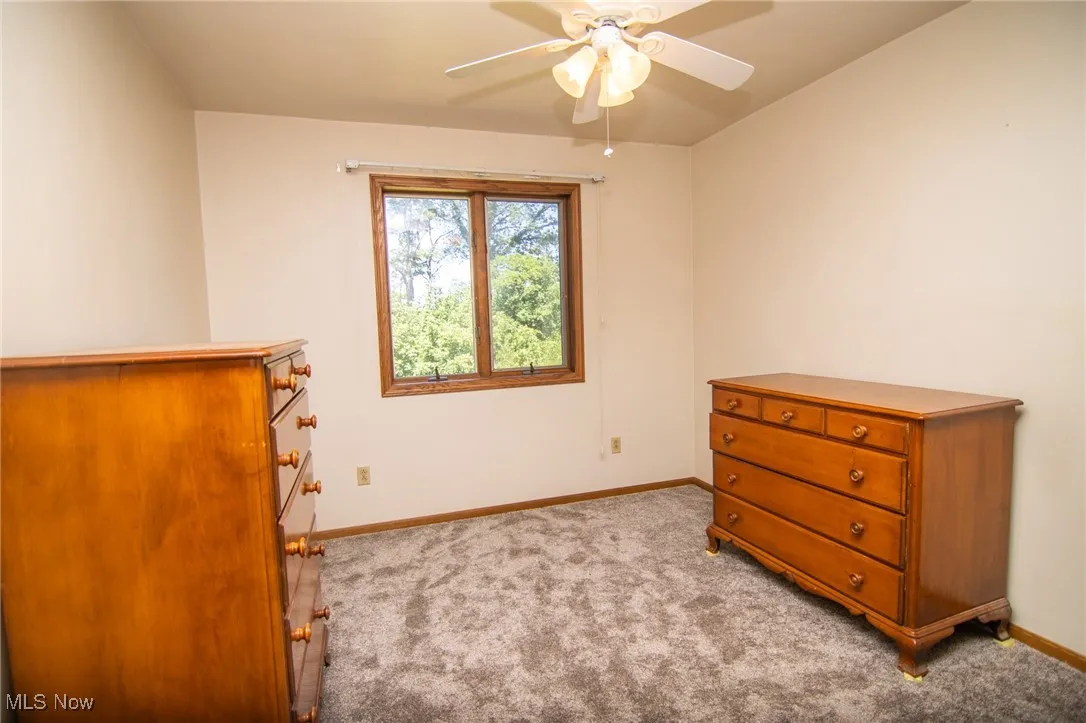 Bedroom featuring light colored carpet and a ceiling fan
