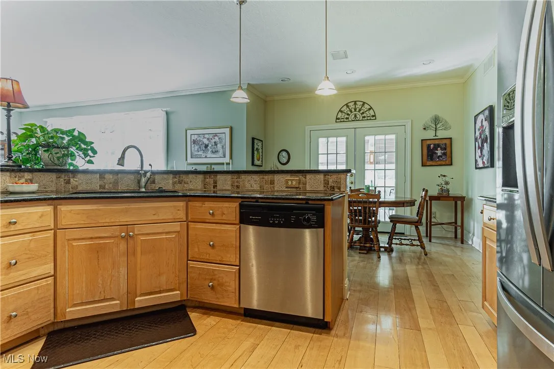 Hardwood maple floors looking towards eating area and 3-seasons room