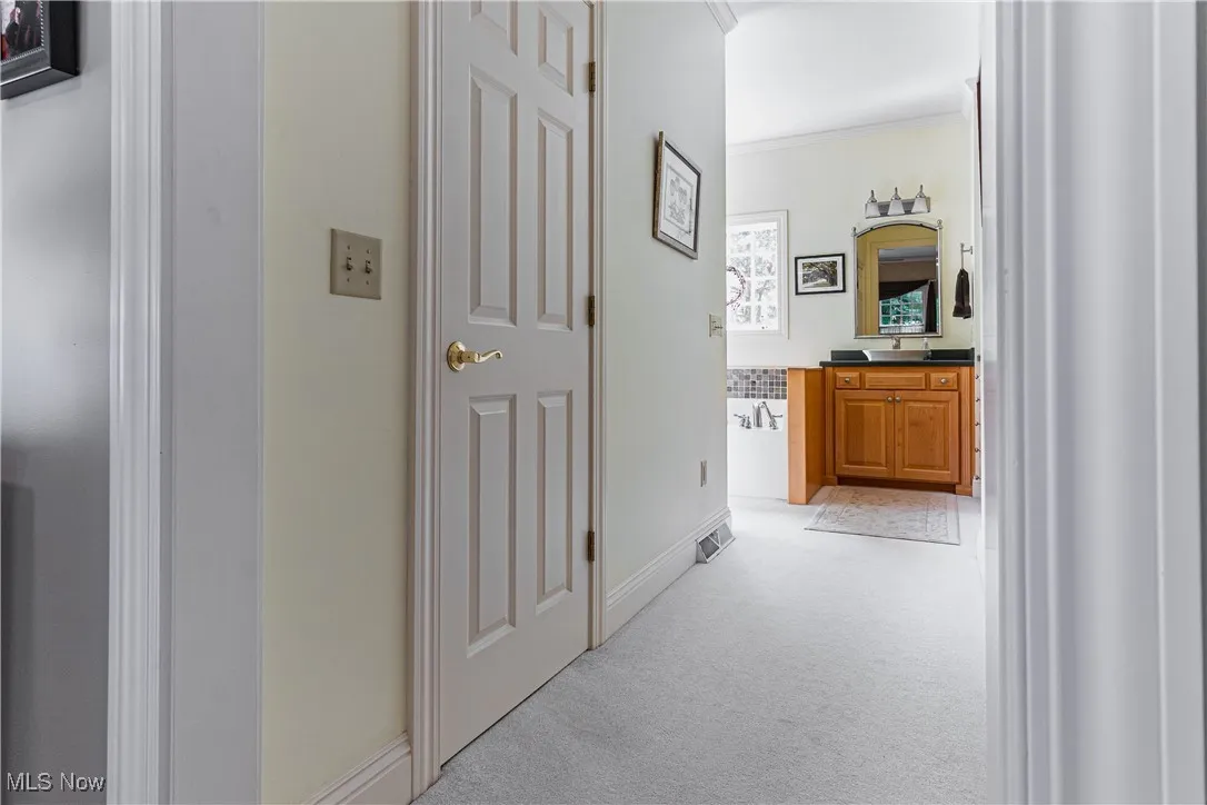 Hallway from master bedroom to walk-in closet, linen closet and master bathroom
