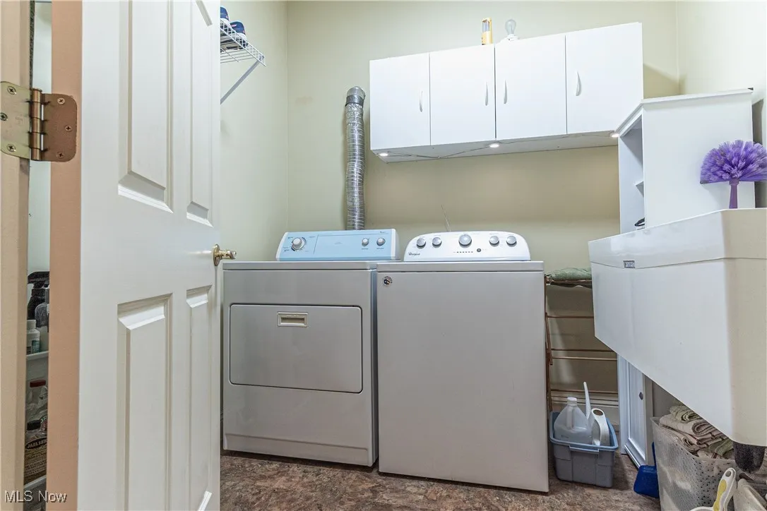 Laundry room next to entry from garage