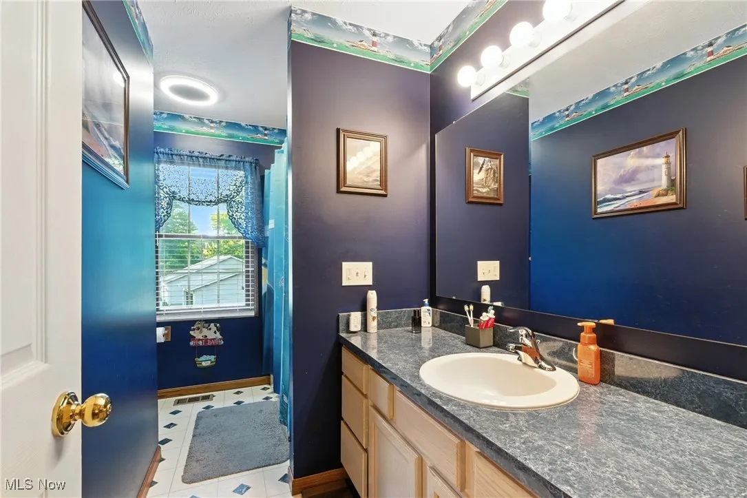 Bathroom featuring vanity and light tile patterned floors