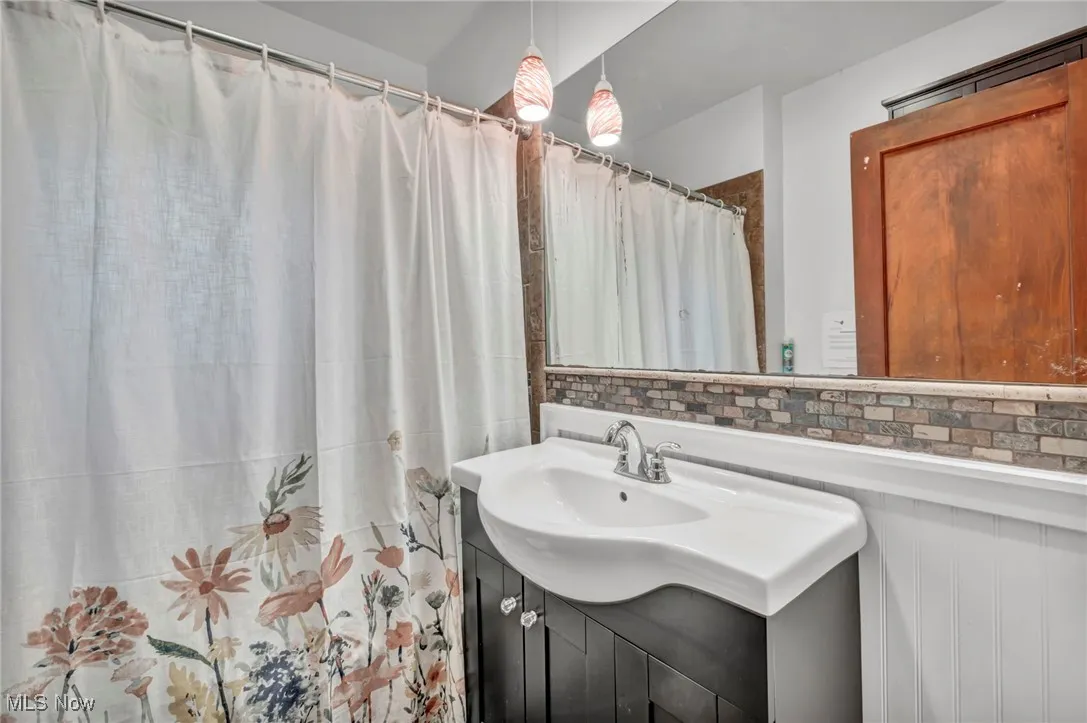 Full bathroom featuring vanity and a shower with curtain