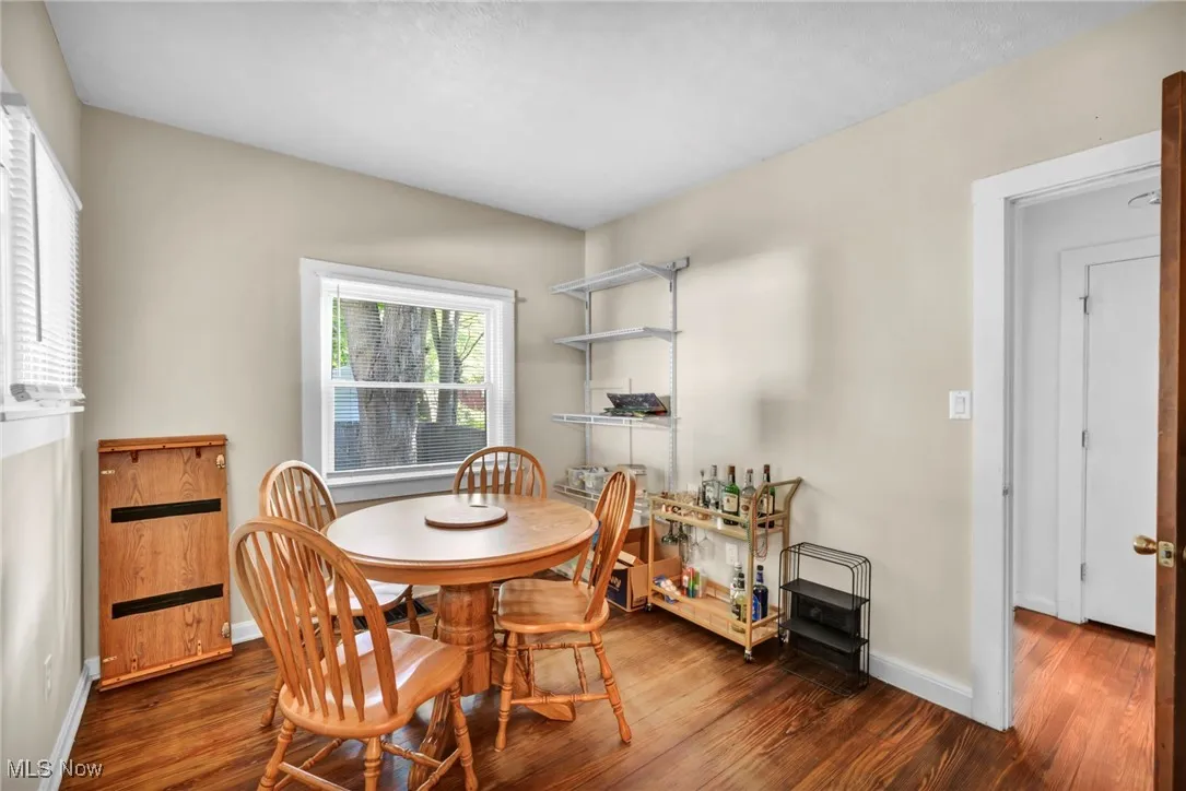Dining room featuring dark wood-style floors