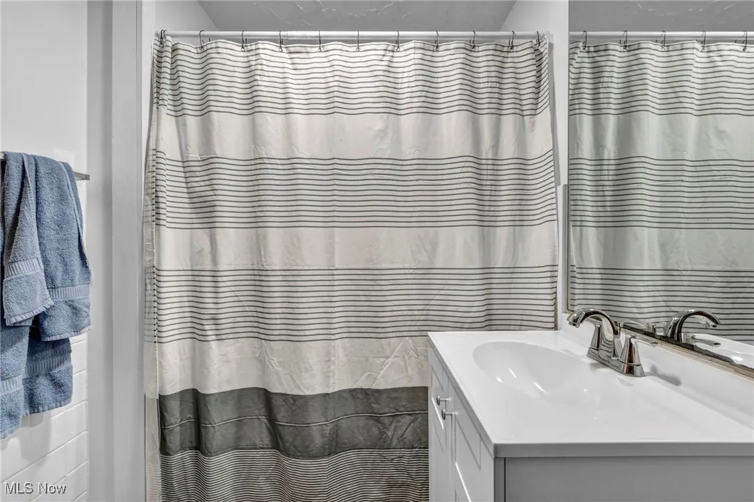 Full bath featuring vanity and a shower with shower curtain