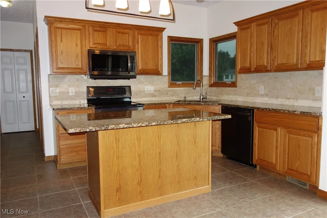 Oak Cabinetry and newer stainless appliances