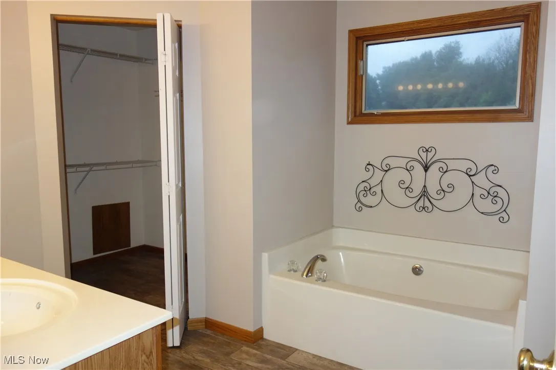 Master Bathroom w/ double sinks, large tub, shower and a walk-in closet
