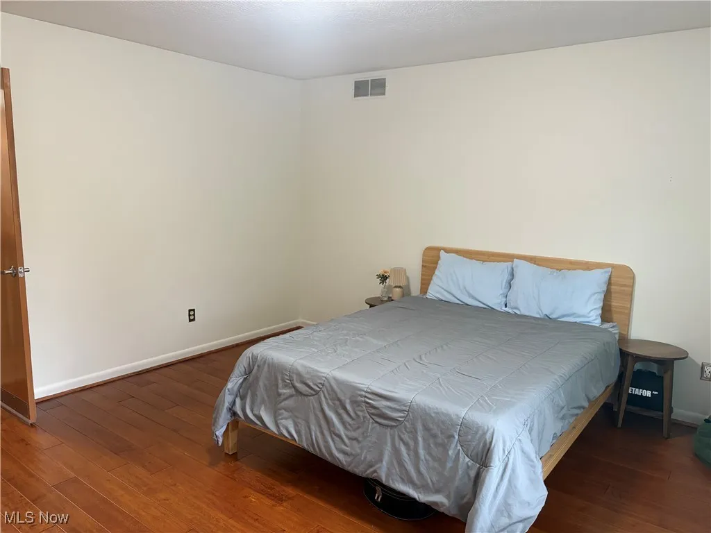 Bedroom with dark wood finished floors
