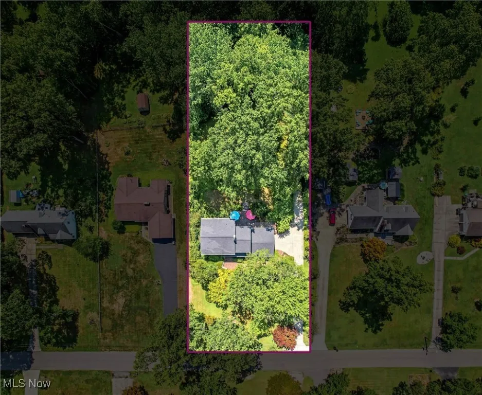Aerial view of property and surrounding area with property parcel outlined