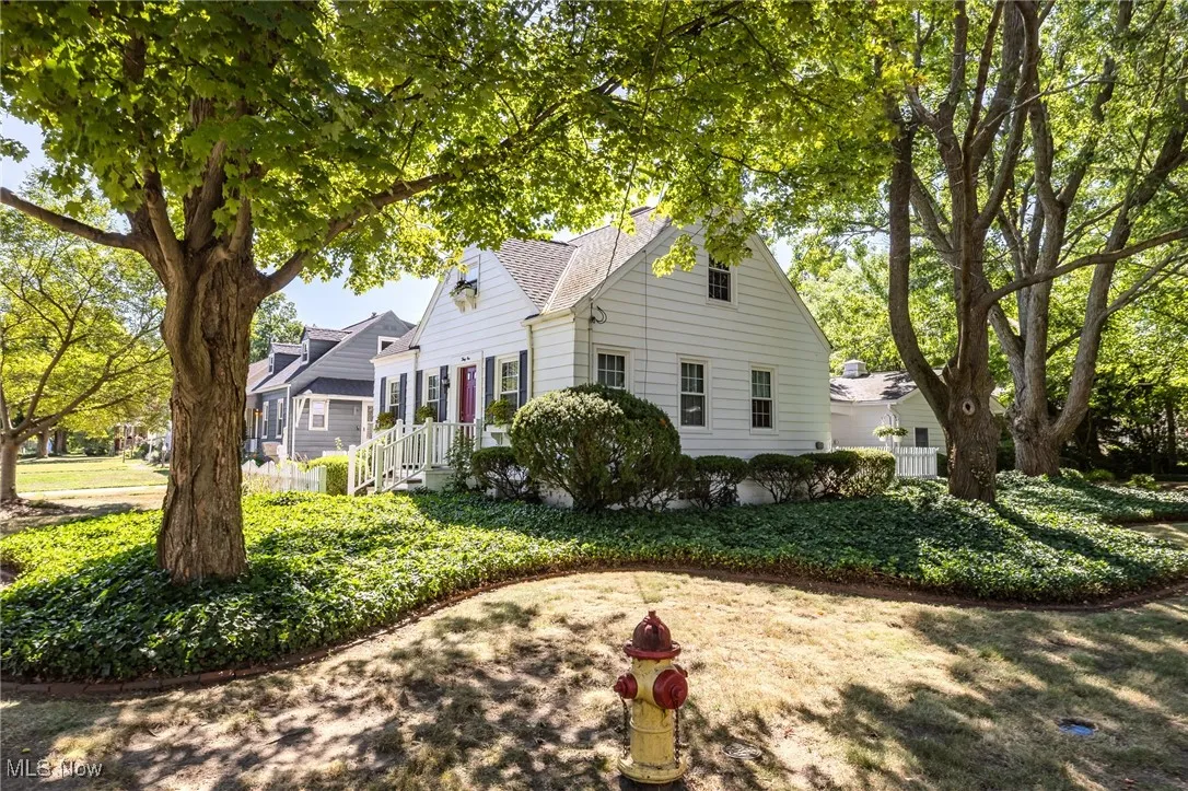 View of side of property featuring a shingled roof