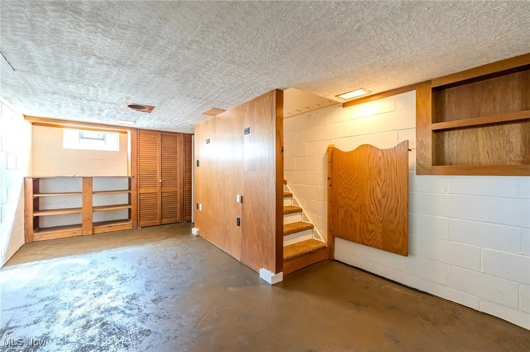 Below grade area with a textured ceiling