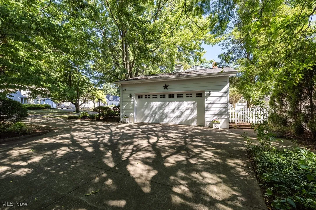 Garage featuring concrete driveway
