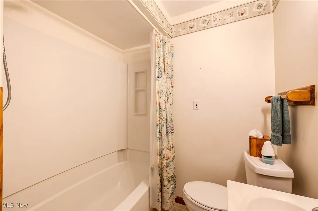 Bathroom featuring shower / tub combo and vanity