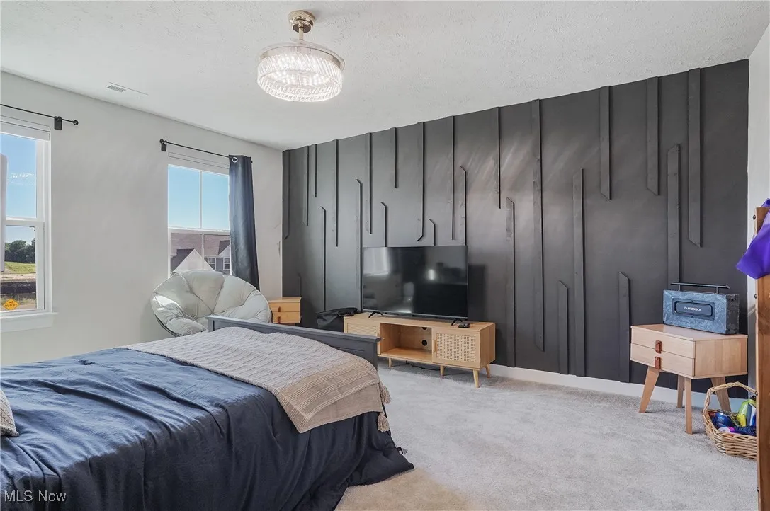 Bedroom with carpet floors and a textured ceiling