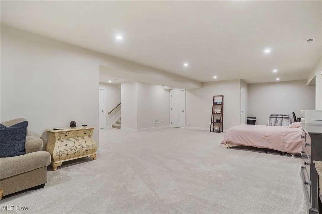 Bedroom with recessed lighting and light colored carpet