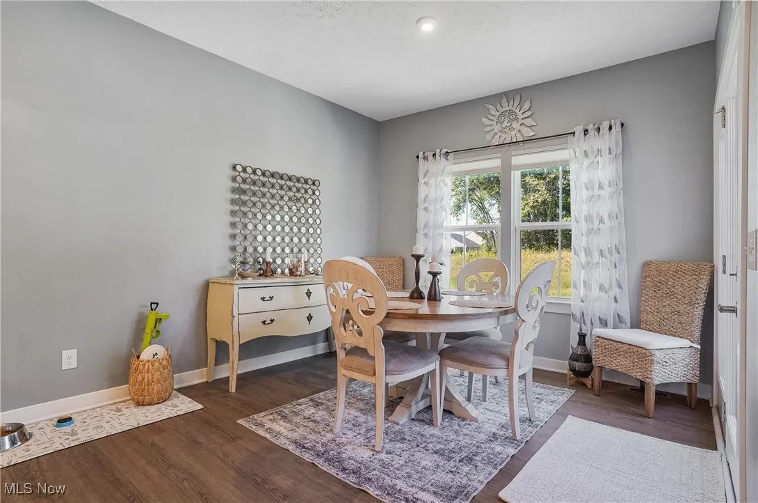 Dining area with dark wood-style flooring and a textured ceiling