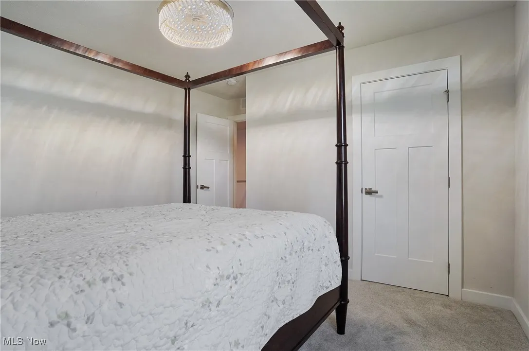 Bedroom featuring carpet flooring and baseboards