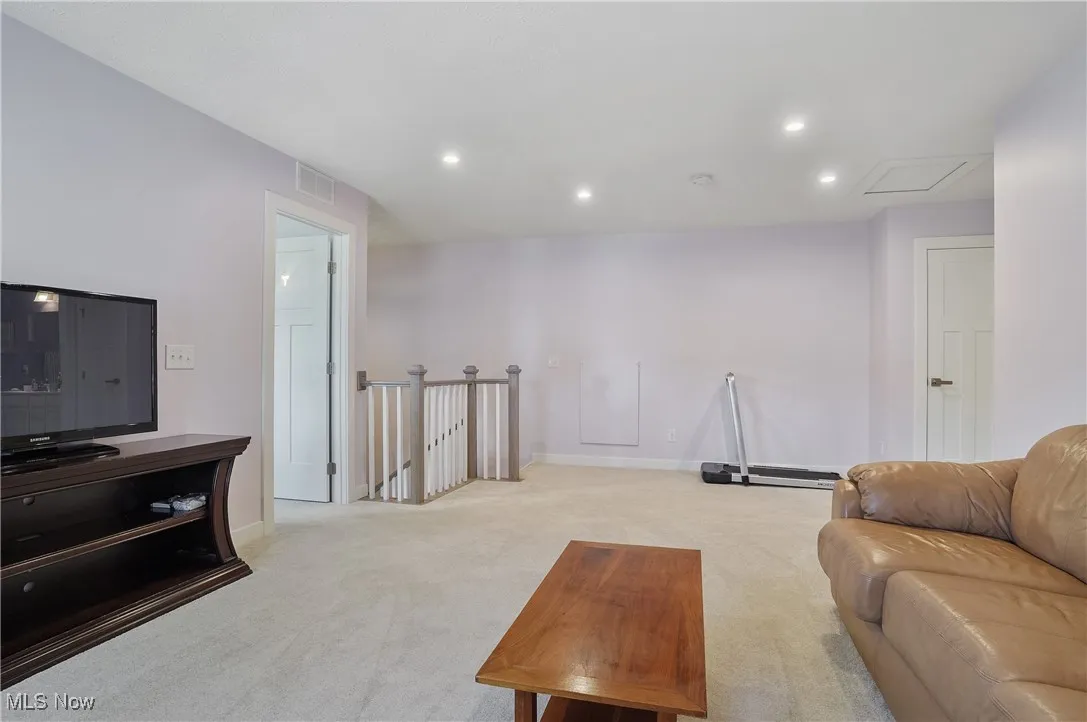 Living room with light carpet and recessed lighting