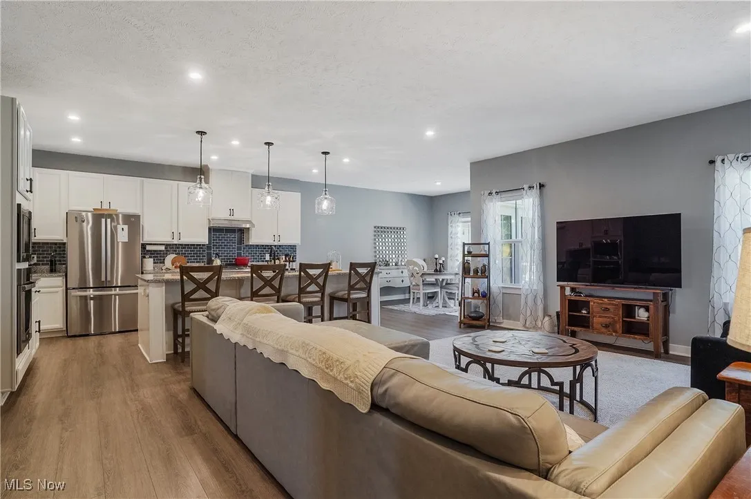 Living area featuring recessed lighting and dark wood-style floors