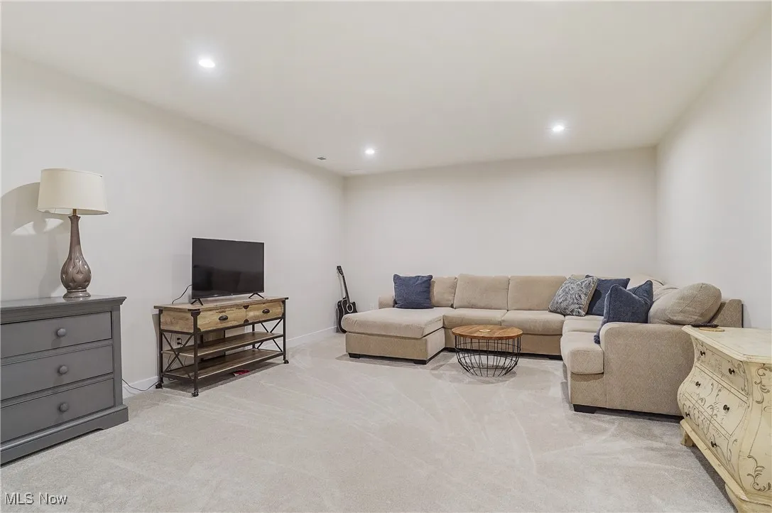 Living area featuring light carpet and recessed lighting