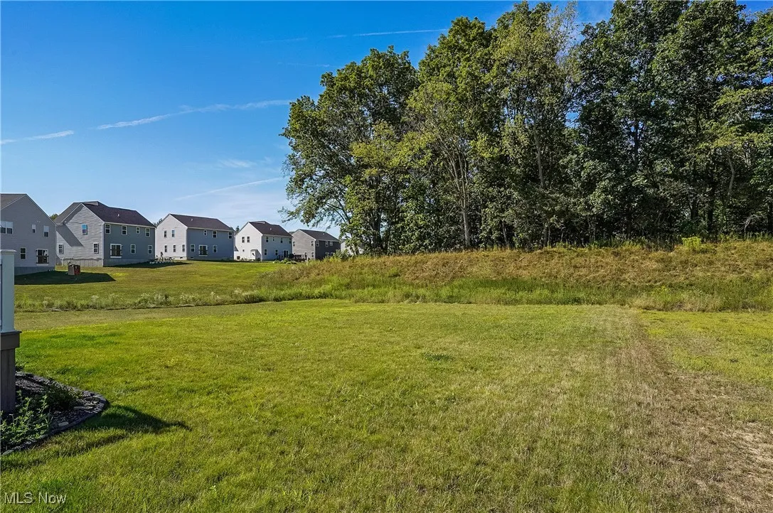 View of green lawn featuring a residential view