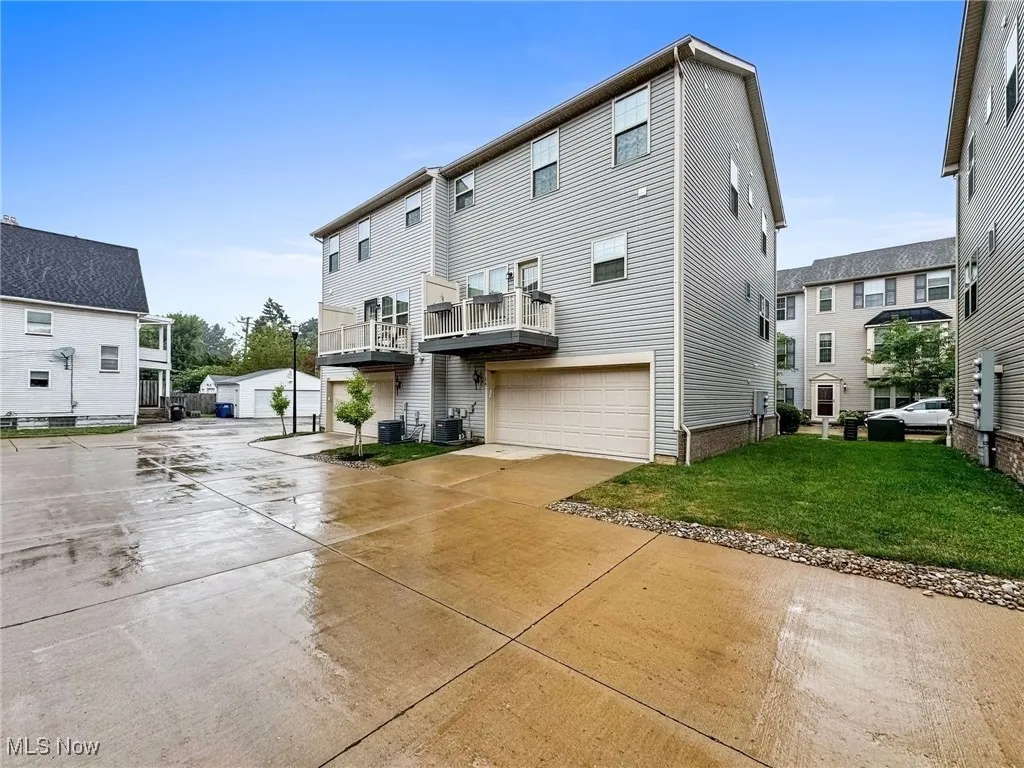 View of home's exterior with a deck, driveway, and a garage