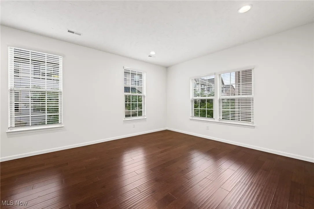 Living room featuring dark wood-style flooring and recessed lighting