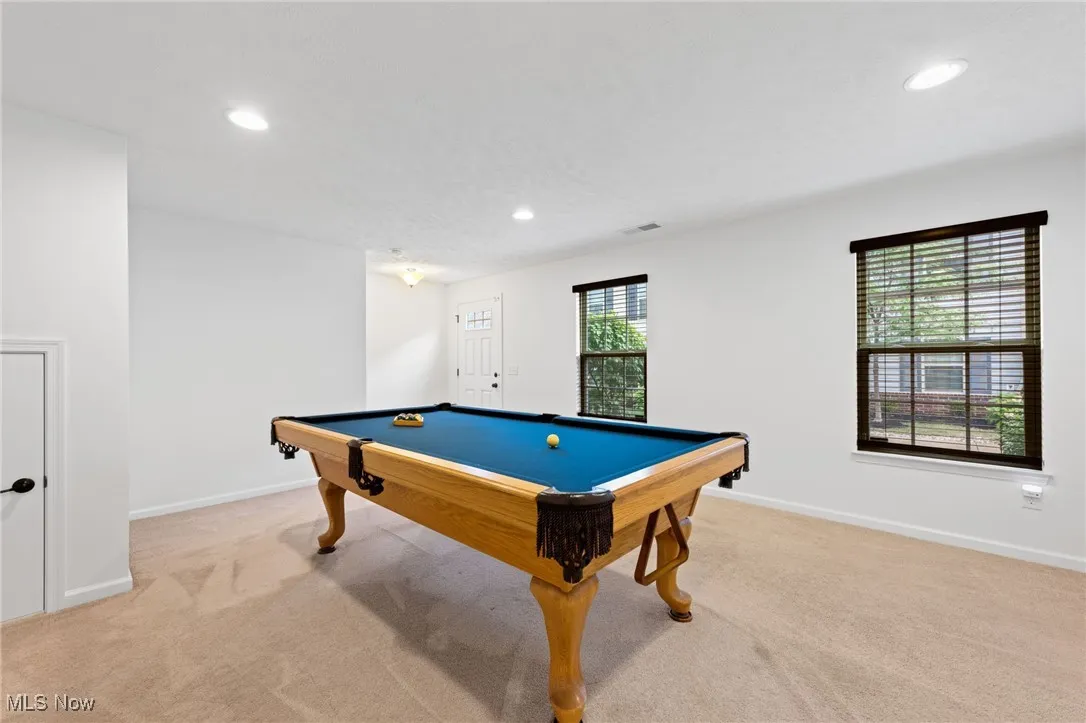 Recreation room with recessed lighting, and light colored carpet
