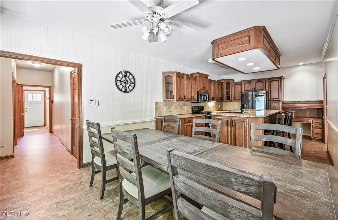 Granite counters & island, stainless steel appliances, ample cabinet space & tiled back splash