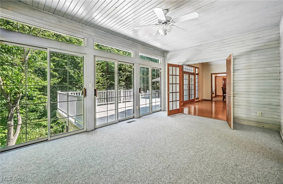 Sunroom featuring french doors and plenty of natural light, deck access