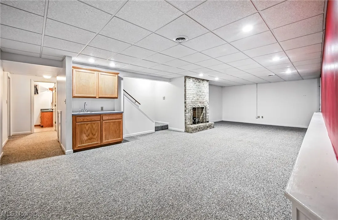 Finished basement with sink, gas fireplace, sizable living area.