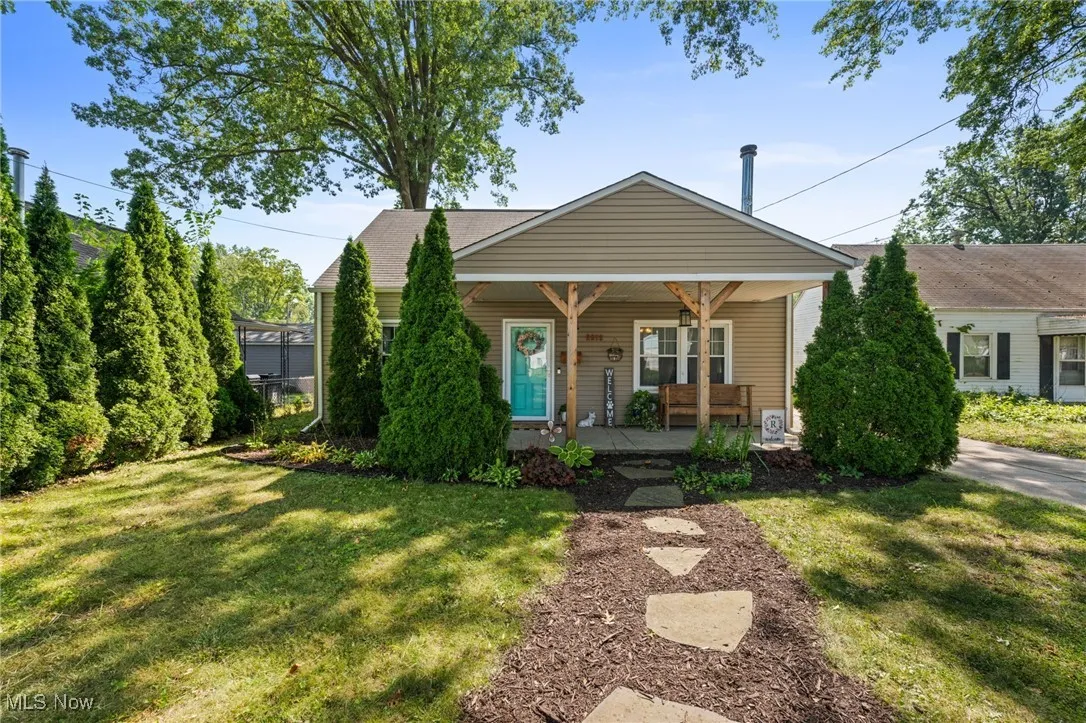 View of front of home with a porch and a front lawn