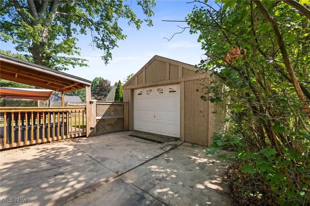 Detached garage featuring concrete driveway