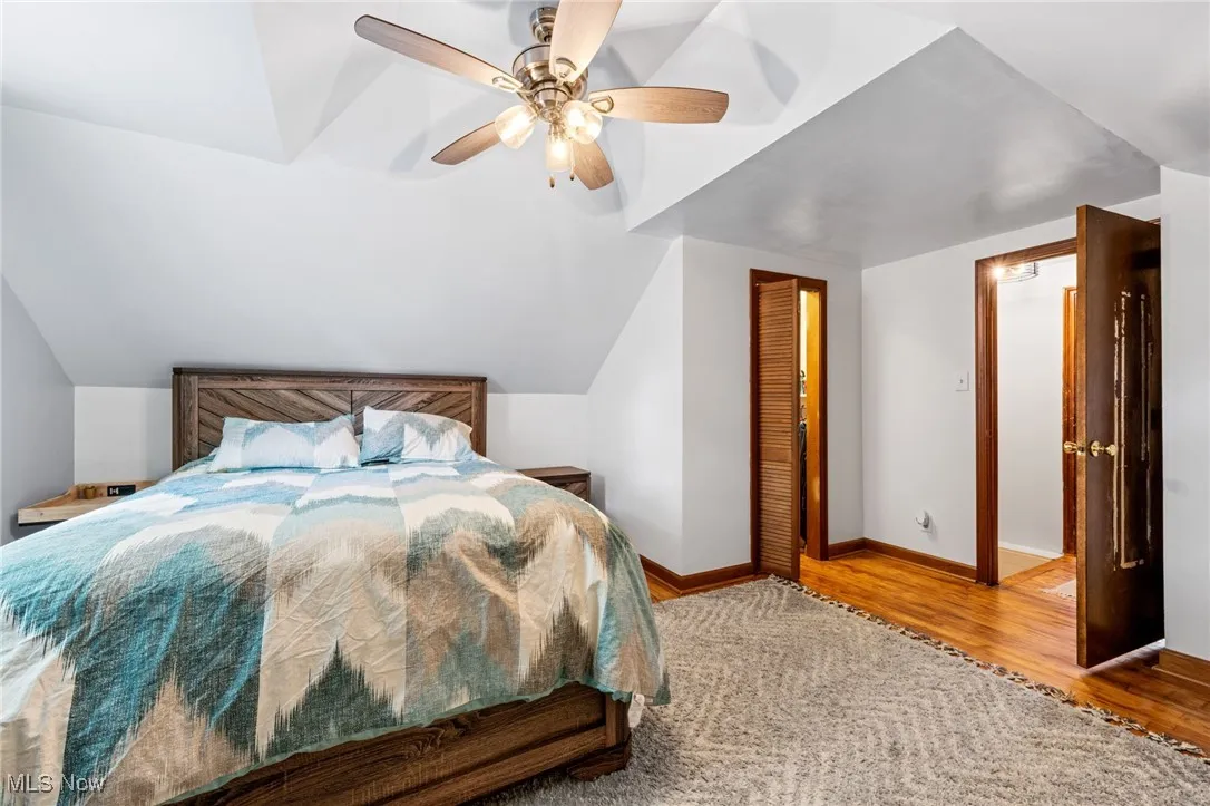 Bedroom featuring lofted ceiling, wood finished floors, and ceiling fan
