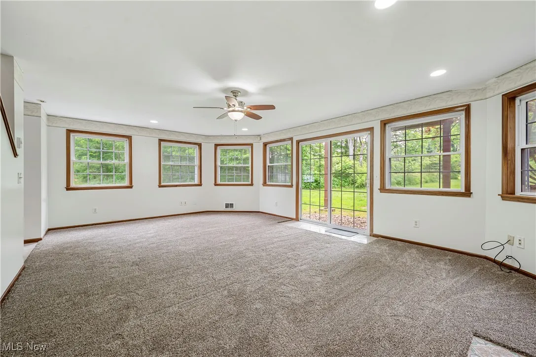 Unfurnished living room with carpet flooring, ceiling fan, and recessed lighting