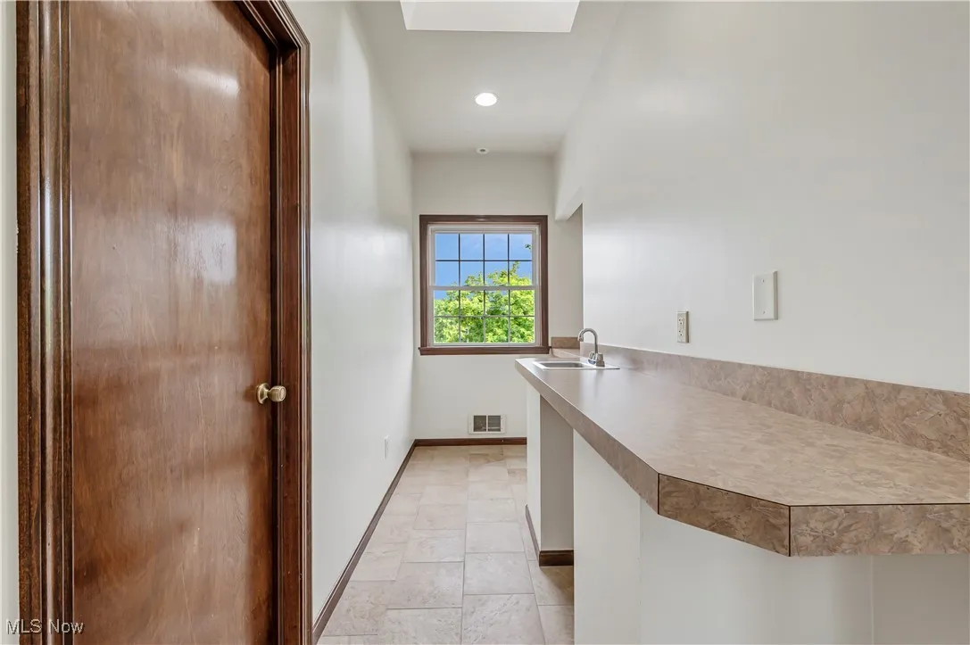 Laundry area featuring a skylight and recessed lighting