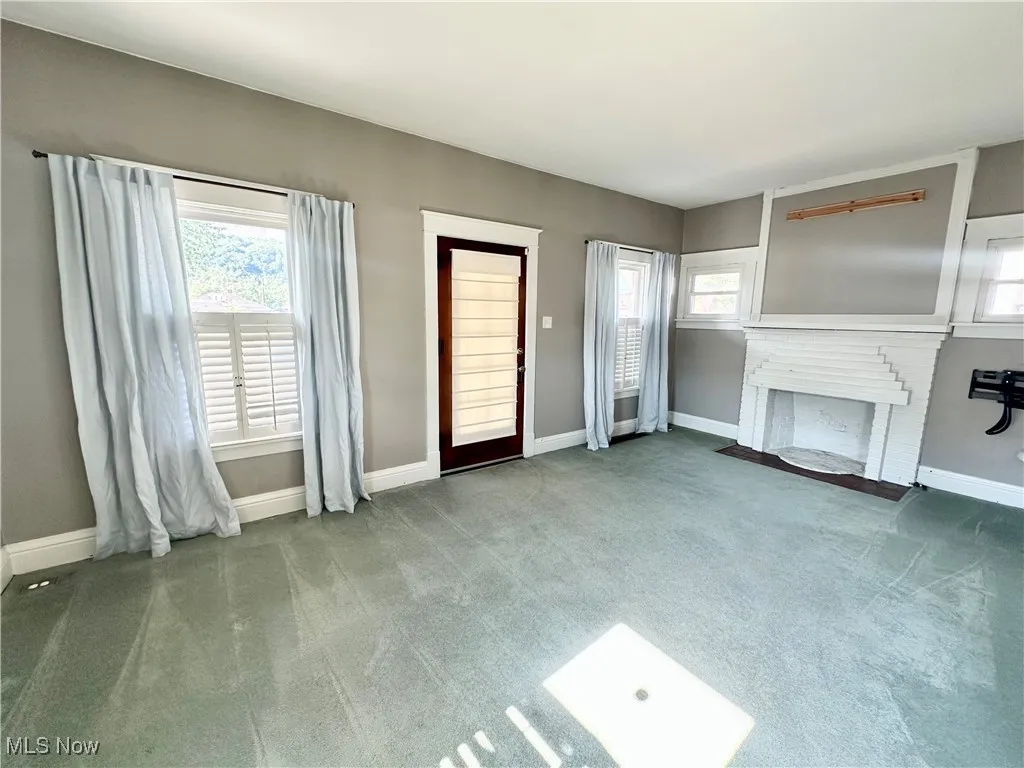 Living room featuring carpet and a fireplace