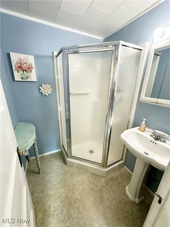 Bathroom featuring a stall shower and sink