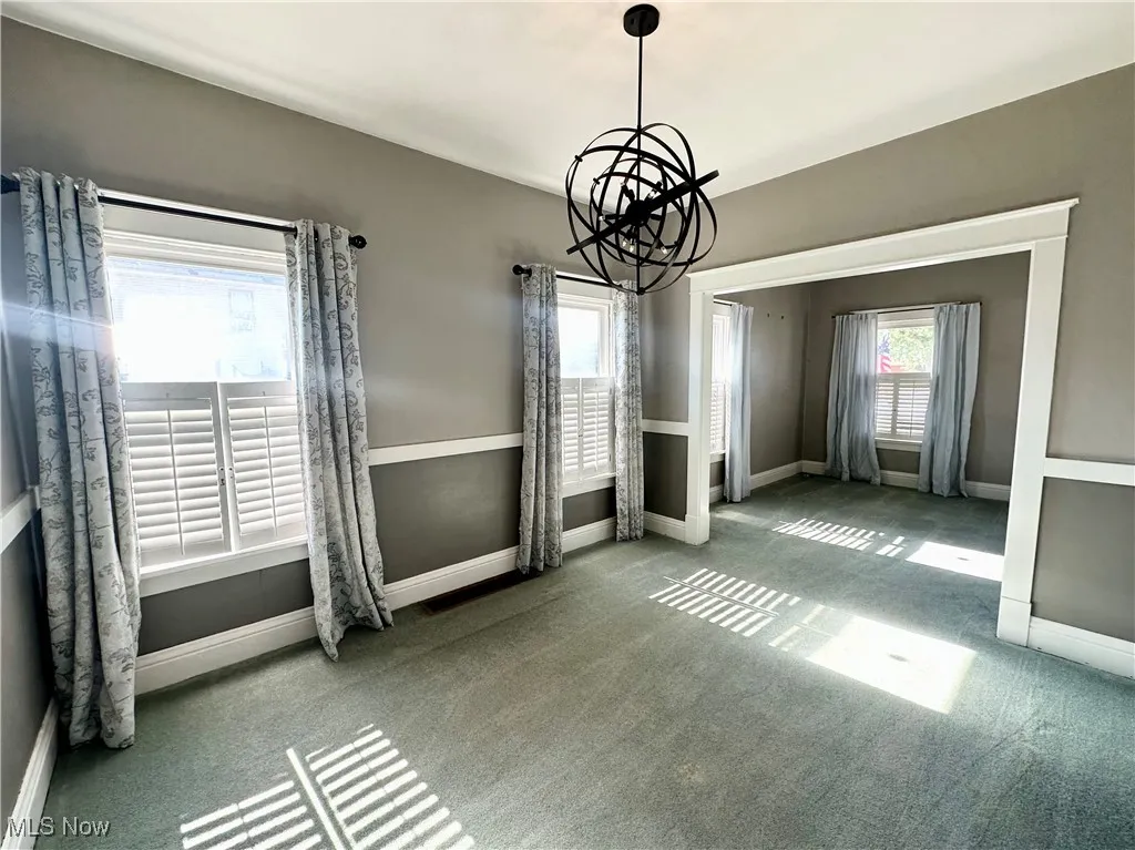 Dining area featuring carpet and a chandelier