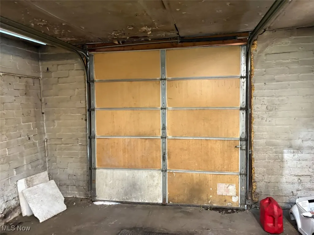 Garage featuring concrete block wall