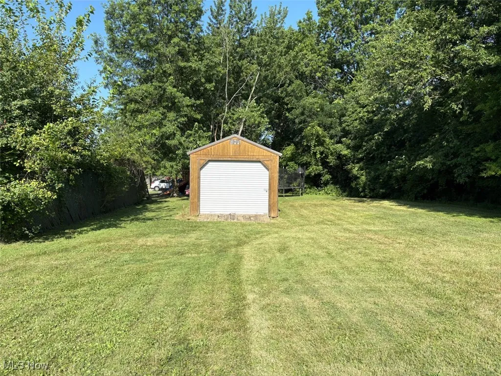 View of green lawn with an outbuilding