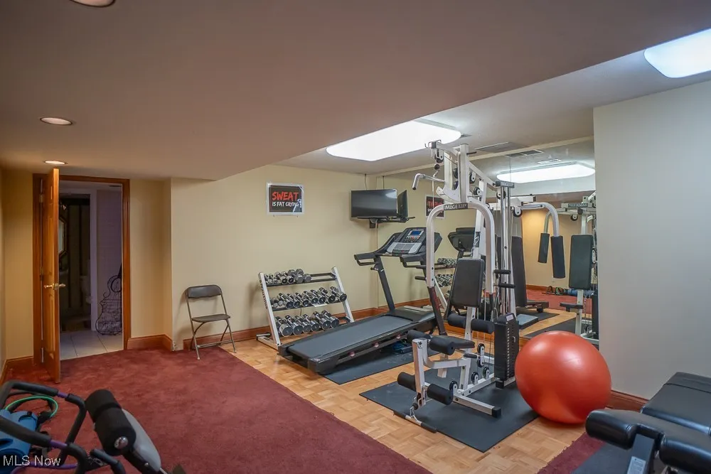 Workout area featuring baseboards and recessed lighting