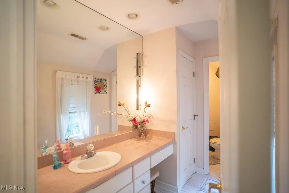 Bathroom with vanity and light tile patterned flooring