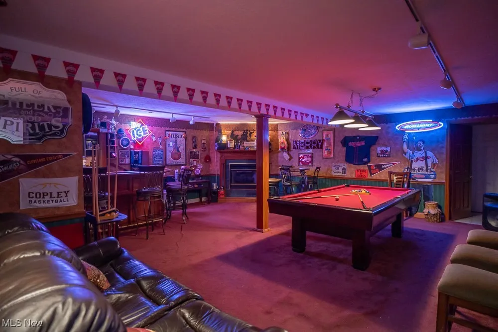 Rec room featuring rail lighting, a bar, pool table, and carpet floors